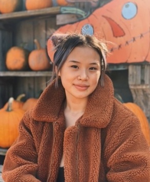 Tristan Henriques ‘25 standing in front of a white wall.