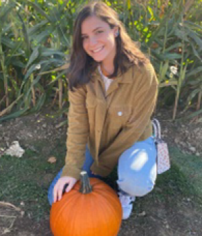 woman holding a pumpkin.