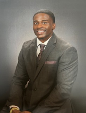 nman wearing business suit, smiling.