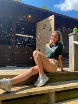 woman sitting on a patio outside.