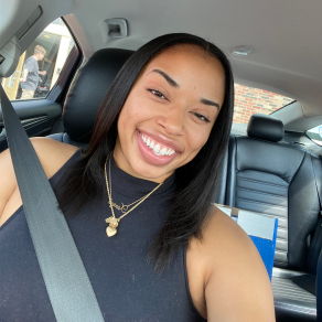 woman smiling,sitting inside a car. 