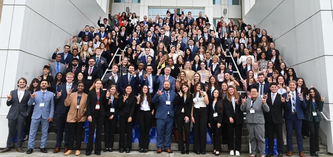 photo of the entire JD Class of 2027 standing on a large stairway. 