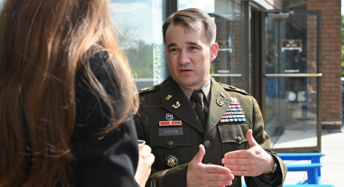 Man in uniform talking to a female law student. 