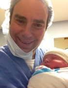 Marc W. Brown ’99 holding his newborn son, Joshua Merrill.
