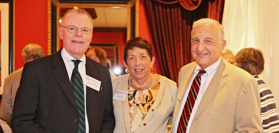 Three people smiling.