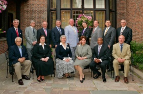 group of alumni standing together, posing for their group photo. 