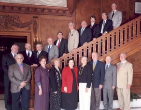 group of alumni posing on a stairwell for a group photo. 