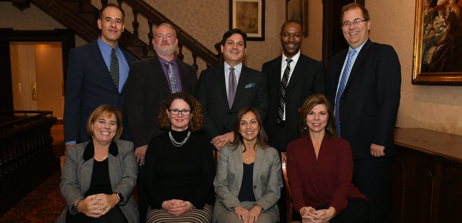 group of people sitting together for a photo.
