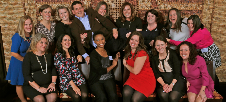 group of alumni gathered for a photo, all smiling.