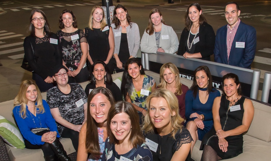 group of alumni gathered for a photo, all smiling.