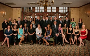 group of people inside a large room, posed for a photo. 