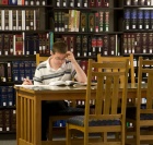 photo of student working in the library.