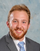 Cegielski wearing business suit, smiling.