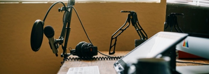 photo of computer desk with microphone and computer.