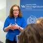 Picture of Professor Kim Connolly teaching a clinical course to a small group of law students. 
