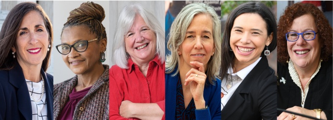 Picture of two new law students at orientation registration table being helped by two current law students.