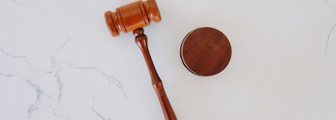 photo of a wooden gavel on a marble table.