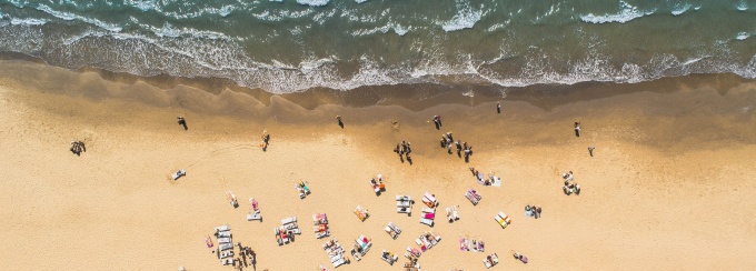 birds eye view of people sitting on a beach.