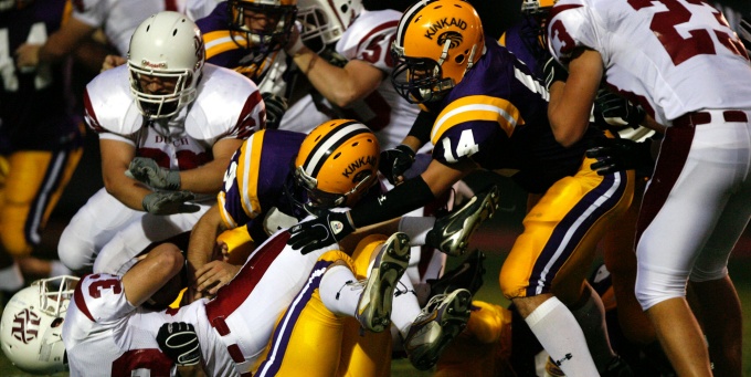 photo of football players in a game.