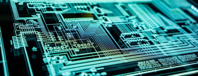 photo of a glowing computer circuit board.