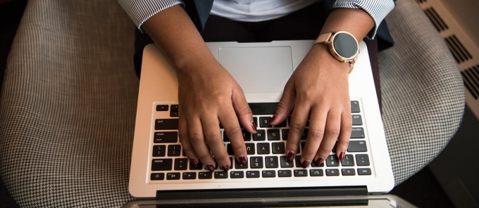 woman with a laptop on her lap.