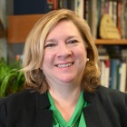 Woman smiling, sitting in her office. 