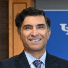 man wearing suite, smiling.