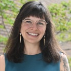 Wilson standing outside next to O'Brian Hall.