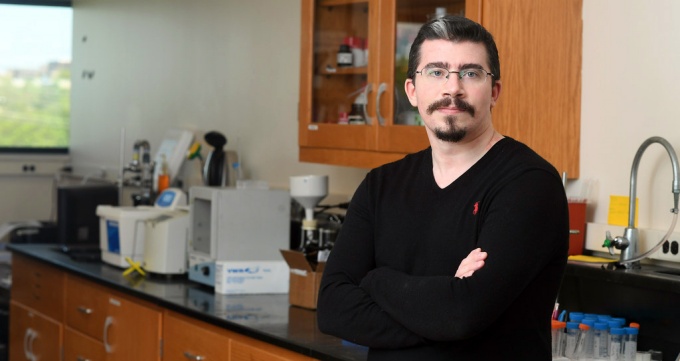 Jonathan Smyth leaning on a counter.