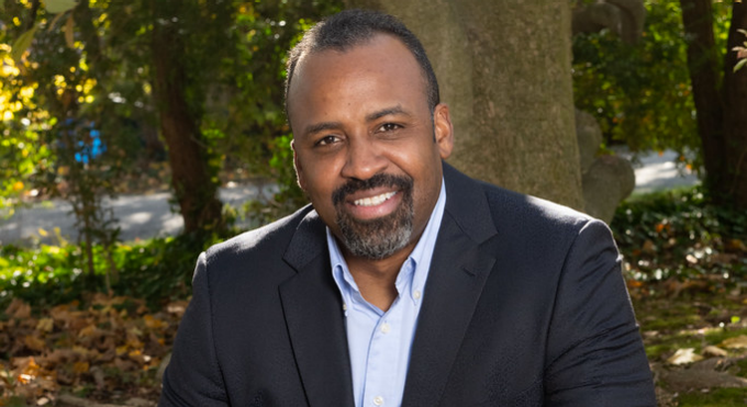 Jonathan Beane outside with some trees.