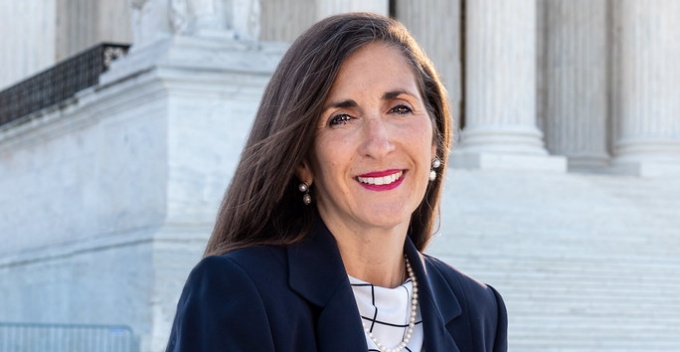 Catherine Cerulli sitting on steps outside courtroom.