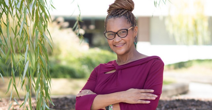 Hughes standing outside next to a willow tree.