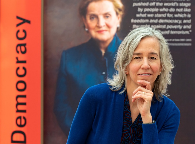 Elizabeth Kim standing in front of a poster.