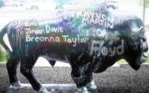 buffalo statue with graffiti on it.