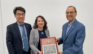 Zoom image: Meredith Kolsky Lewis, professor and vice dean for international and graduate programs, received the 2024 Award for Outstanding Contributions to International Education, presented by UB’s Council on International Studies and Programs. (Pictured with Professor Nojin Kwak, UB's vice provost for international education, left, and UB President Satish Tripathi, right.) 