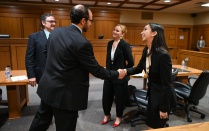 UB Law students in the courtroom shaking hands.