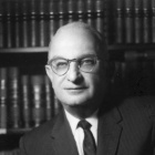 Harry Rachlin in front of bookshelves.