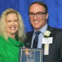 Melissa Nickson '97 presents Christopher A. Wightman '99 with the Distinguished Alumnus Award for Business. 