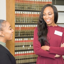 Tolu talking with students.