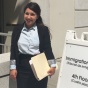 Shelby Scibetta standing outside a government building. 