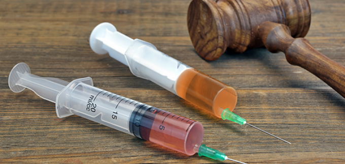photo of two syringes and a judges gavel.