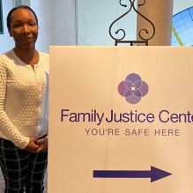 Aldiama Anthony standing with a sign.