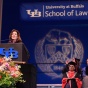 Hochul standing at a podium, delivering the keynote address at the School of Law’s 2017 Commencement Ceremony. 