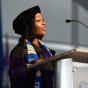 student standing at a podium during commencement. 