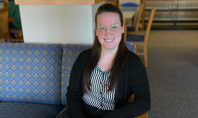 woman sitting on a sofa inside the library.