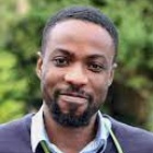 man smiling, wearing blue sweater and smiling.