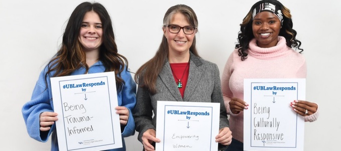 three people holding up signs.