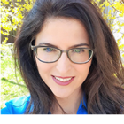 woman outside, smiling.