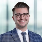 man smiling, arms crossed.