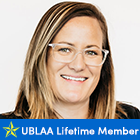 woman wearing glasses, smiling, text that says UBLAA Lifetime Member. 